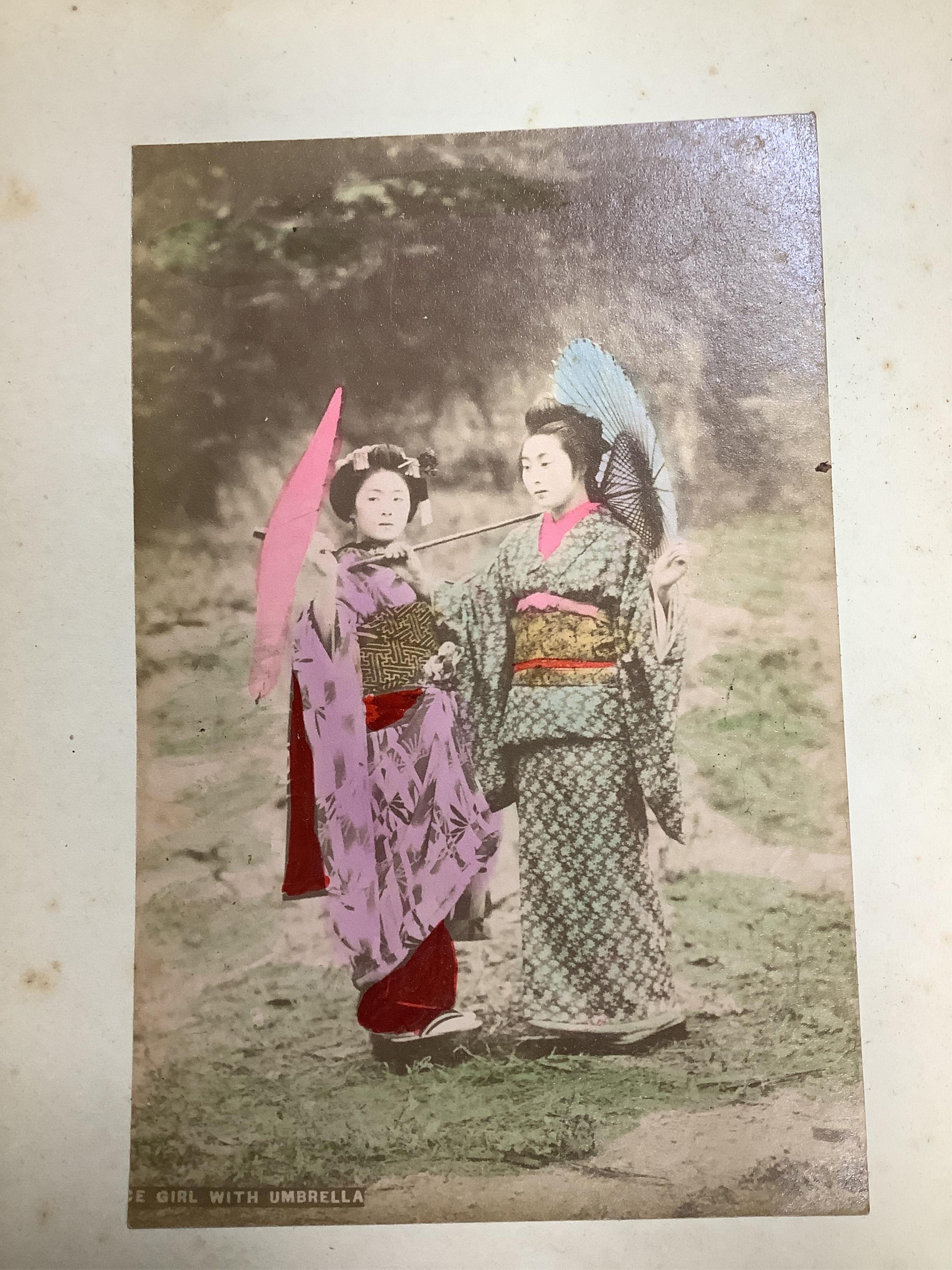 An early 20th century Japanese bone inlaid lacquer photograph album containing coloured photographs of people and Japanese scenes.19.5cm wide x 15.5cm high